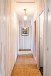 Bright hallway leading to bedrooms and bathroom